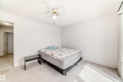 Carpeted room with a ceiling fan light fixture and white painted walls - 14123 96 Street, Edmonton, AB 