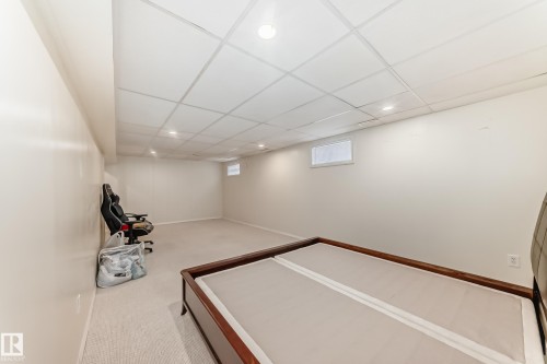 Spacious room with light-colored carpeting and off-white walls - 14123 96 Street, Edmonton, AB 