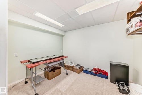 Room featuring light-colored carpet, white walls, and a dropped ceiling with recessed lighting - 14123 96 Street, Edmonton, AB 