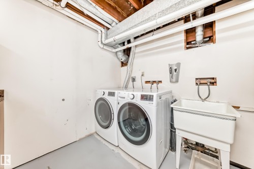 Laundry area featuring a utility sink and exposed ceiling joists - 14123 96 Street, Edmonton, AB 