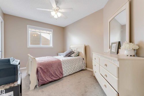 Carpeted room with a ceiling fan, a window, and neutral wall paint - 121 64 Street, Edmonton, AB - Indoor Photo Showing Bedroom