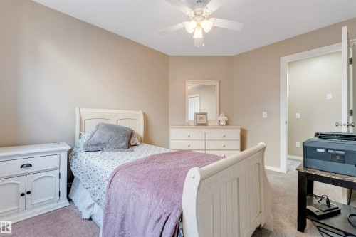 Neutral-toned walls and plush carpeting define this interior space - 121 64 Street, Edmonton, AB - Indoor Photo Showing Bedroom
