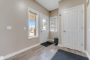 Entryway featuring wood-finish flooring, a white paneled door with decorative glass, and a large side window - 121 64 Street, Edmonton, AB  - Indoor Photo Showing Other Room 