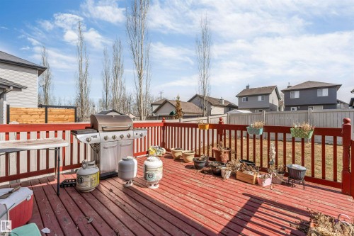 Spacious wooden deck with red railing and balusters - 121 64 Street, Edmonton, AB - Outdoor With Deck Patio Veranda With Exterior