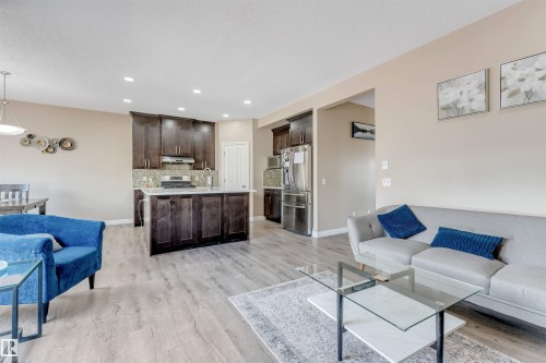 Open-concept living space featuring wood-finish flooring throughout - 121 64 Street, Edmonton, AB - Indoor Photo Showing Living Room