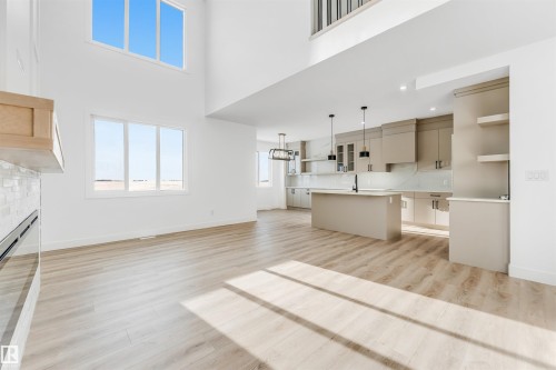 This property features an open-concept layout with light-colored flooring and white walls, creating a bright and airy atmosphere - 4102 67 Street, Beaumont, AB - Indoor Photo Showing Kitchen