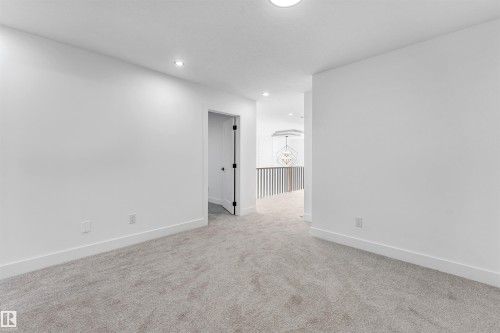 This versatile space features carpeting, white walls, and recessed lighting, offering a blank canvas for customization - 4102 67 Street, Beaumont, AB - Indoor Photo Showing Other Room