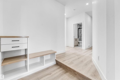 Bright hallway featuring light wood-style flooring and recessed lighting - 4102 67 Street, Beaumont, AB - Indoor Photo Showing Other Room