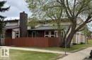 Townhome-style exterior with beige siding and brick accents - 17106 108 St Nw, Edmonton, AB  - Outdoor 