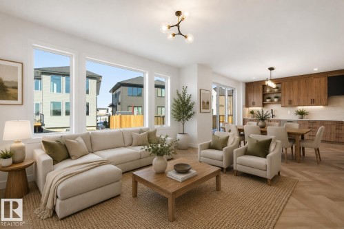 Open-concept living area featuring a spacious layout, large windows, wood-finish flooring, a contemporary kitchen with wood cabinetry, and a dining area with a modern chandelier - 17108 2 Street, Edmonton, AB - Indoor Photo Showing Living Room