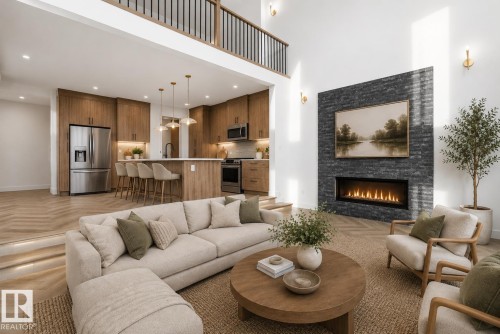 Vaulted ceiling living area featuring a linear fireplace with a textured black stone surround, light wood-finish flooring, and a kitchen with warm-toned cabinetry - 17107 3 Street Nw, Edmonton, AB - Indoor Photo Showing Living Room With Fireplace