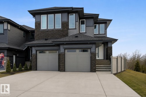 Contemporary exterior showcasing dark siding and stone accents - 17107 3 Street Nw, Edmonton, AB - Outdoor