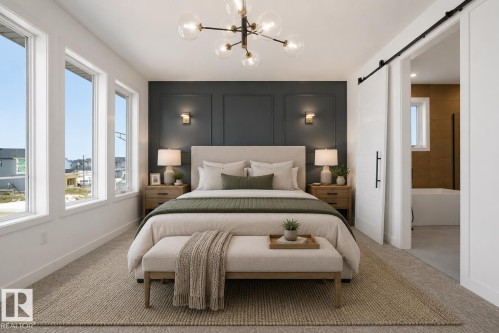 Bedroom featuring multiple tall windows, a dark accent wall with panel molding, and recessed wall sconces - 17107 3 Street Nw, Edmonton, AB - Indoor Photo Showing Bedroom
