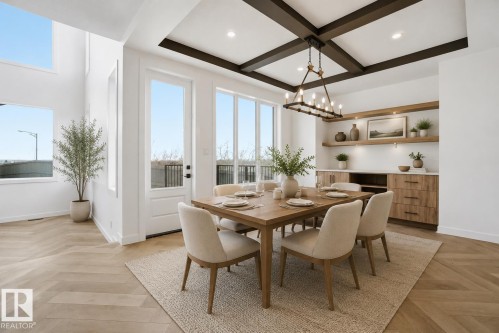 Dining area featuring a coffered ceiling with a linear chandelier, wood-finish flooring in a herringbone pattern, and built-in cabinetry with open shelving - 17107 3 Street Nw, Edmonton, AB - Indoor Photo Showing Dining Room
