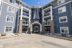 Multi-story building with blue siding and stone facade accents - 