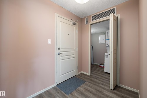 Entryway featuring wood-finish flooring and a neutral color palette - 406 16035 132 Street, Edmonton, AB - Indoor Photo Showing Other Room