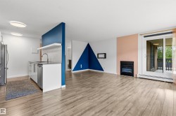 Open-concept living area with wood-finish flooring - 