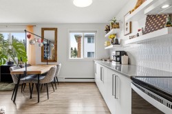 Kitchen and dining area featuring wood-finish flooring - 