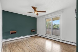 Room featuring wood-finish flooring, a ceiling fan with integrated lighting, and a sliding glass door leading to a balcony - 