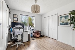 Spacious room featuring wood-finish flooring, a large window, a ceiling light fixture, and bifold closet doors - 