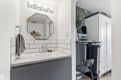 Modern vanity featuring a built-in sink, dark cabinetry, and white countertop - 