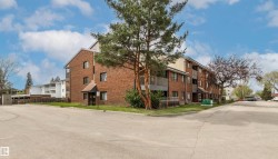 Multi-story brick building with multiple balconies and a covered entrance - 