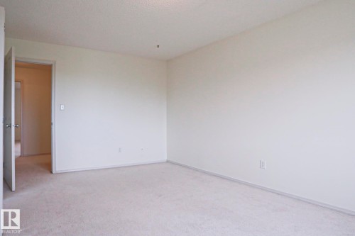 Carpeted room with light-colored walls and baseboards - 1627 Melrose Place Sw, Edmonton, AB - Indoor Photo Showing Other Room