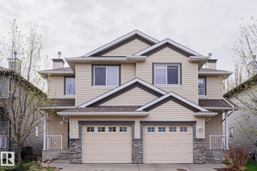 Two-story duplex featuring horizontal siding, multiple gables, and stone accents - 1627 Melrose Place Sw, Edmonton, AB - Outdoor With Facade
