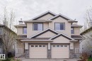 Two-story duplex featuring horizontal siding, multiple gables, and stone accents - 1627 Melrose Place Sw, Edmonton, AB  - Outdoor With Facade 