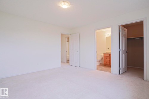 Spacious room featuring light-colored carpeting and white walls - 1627 Melrose Place Sw, Edmonton, AB - Indoor Photo Showing Other Room