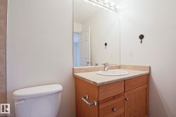 Bathroom vanity featuring a light wood-finish cabinet with storage, a surface-mounted sink, and a laminate countertop - 