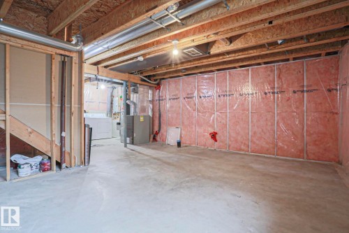 Unfinished basement featuring exposed wood joists, concrete flooring, and insulated perimeter walls - 1627 Melrose Place Sw, Edmonton, AB - Indoor Photo Showing Basement