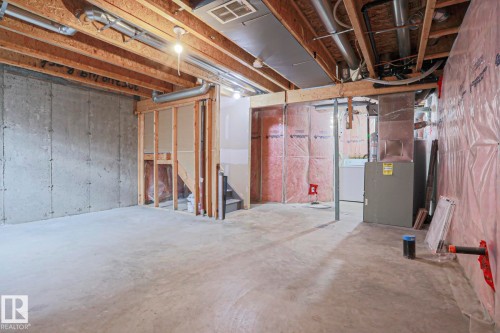Unfinished basement presenting concrete flooring, exposed ceiling joists, and structural framing - 1627 Melrose Place Sw, Edmonton, AB - Indoor Photo Showing Basement