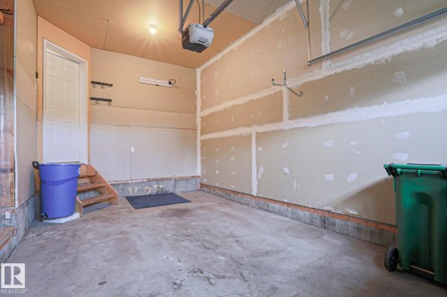 Spacious garage featuring a concrete floor, overhead lighting, and an automatic garage door opener - 1627 Melrose Place Sw, Edmonton, AB - Indoor Photo Showing Other Room