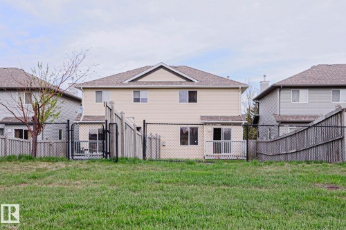 Expansive grassy area bordering a chain-link fence - 1627 Melrose Place Sw, Edmonton, AB - Outdoor With Exterior