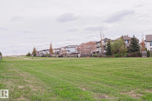 Expansive green space featuring a walking path and mature landscaping - 1627 Melrose Place Sw, Edmonton, AB - Outdoor