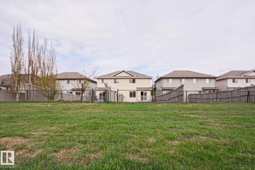 Expansive green space with distant residential properties featuring wood fencing - 1627 Melrose Place Sw, Edmonton, AB - Outdoor