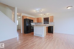 Open-concept living area featuring wood-finish flooring - 