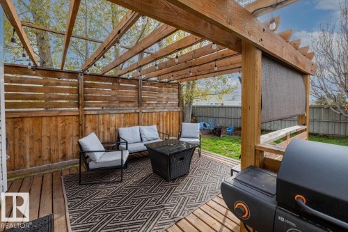 Expansive wood deck featuring a pergola structure with integrated string lighting - 3570 Mclean Crescent, Edmonton, AB - Outdoor With Deck Patio Veranda With Exterior