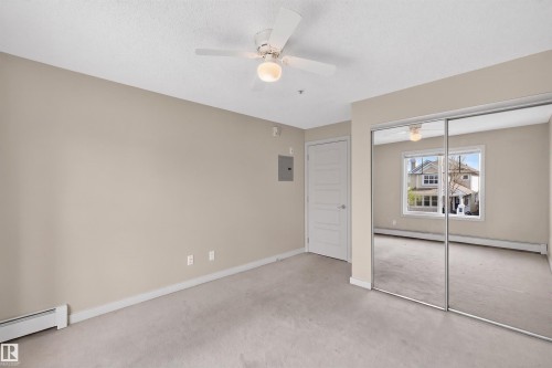 Bedroom featuring a ceiling fan with integrated lighting, neutral-toned walls, and soft carpet flooring - 215 6084 Stanton Drive, Edmonton, AB - Indoor Photo Showing Other Room