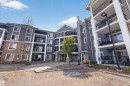 Multi-story building featuring stone veneer and horizontal siding - 215 6084 Stanton Drive, Edmonton, AB  - Outdoor With Balcony With Facade 