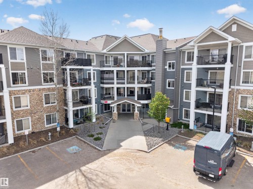 Multi-story residential building featuring a stone and siding exterior - 215 6084 Stanton Drive, Edmonton, AB - Outdoor With Balcony With Facade