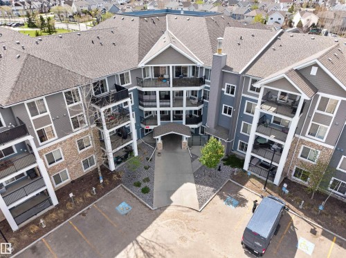 Multi-level residential building featuring a prominent central entrance canopy - 215 6084 Stanton Drive, Edmonton, AB - 
