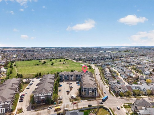 Four-story residential building featuring balconies and a gabled roof - 215 6084 Stanton Drive, Edmonton, AB - Outdoor With View
