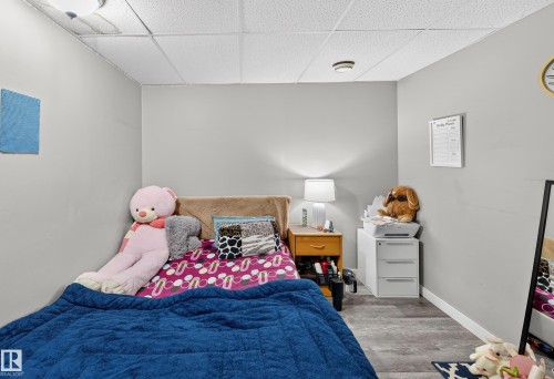 The room features light gray walls and wood-look flooring - 3517 25 Street, Edmonton, AB - Indoor Photo Showing Bedroom