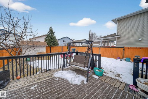 The property features a wooden deck with dark railings, providing an outdoor area - 3517 25 Street, Edmonton, AB - Outdoor With Deck Patio Veranda
