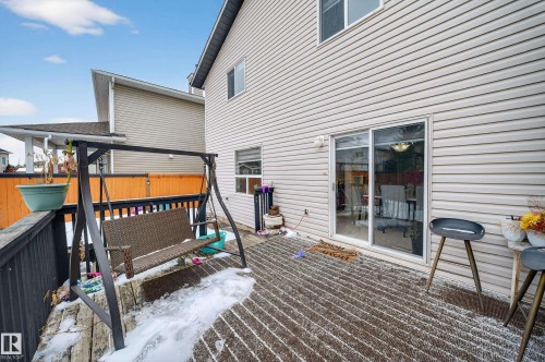 The property features a private deck with durable wood decking and a sliding glass door providing access to the interior - 3517 25 Street, Edmonton, AB - Outdoor With Exterior