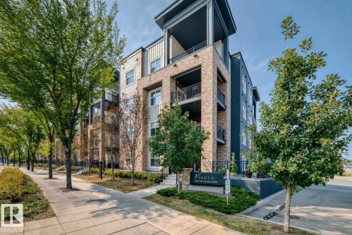 Modern multi-story building featuring a brick and siding exterior with individual balconies - 327 508 Griesbach Parade, Edmonton, AB - Outdoor