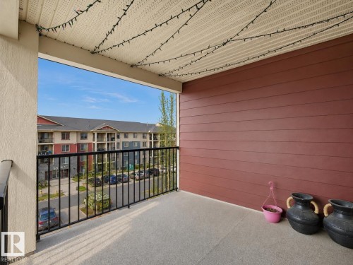 Private balcony featuring durable composite decking and black metal railings - 422 5816 Mullen Place, Edmonton, AB - Outdoor With Exterior