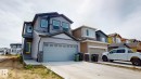 The property features a two-story design with gray siding and stone accents - 607 31 Avenue, Edmonton, AB  - Outdoor With Facade 